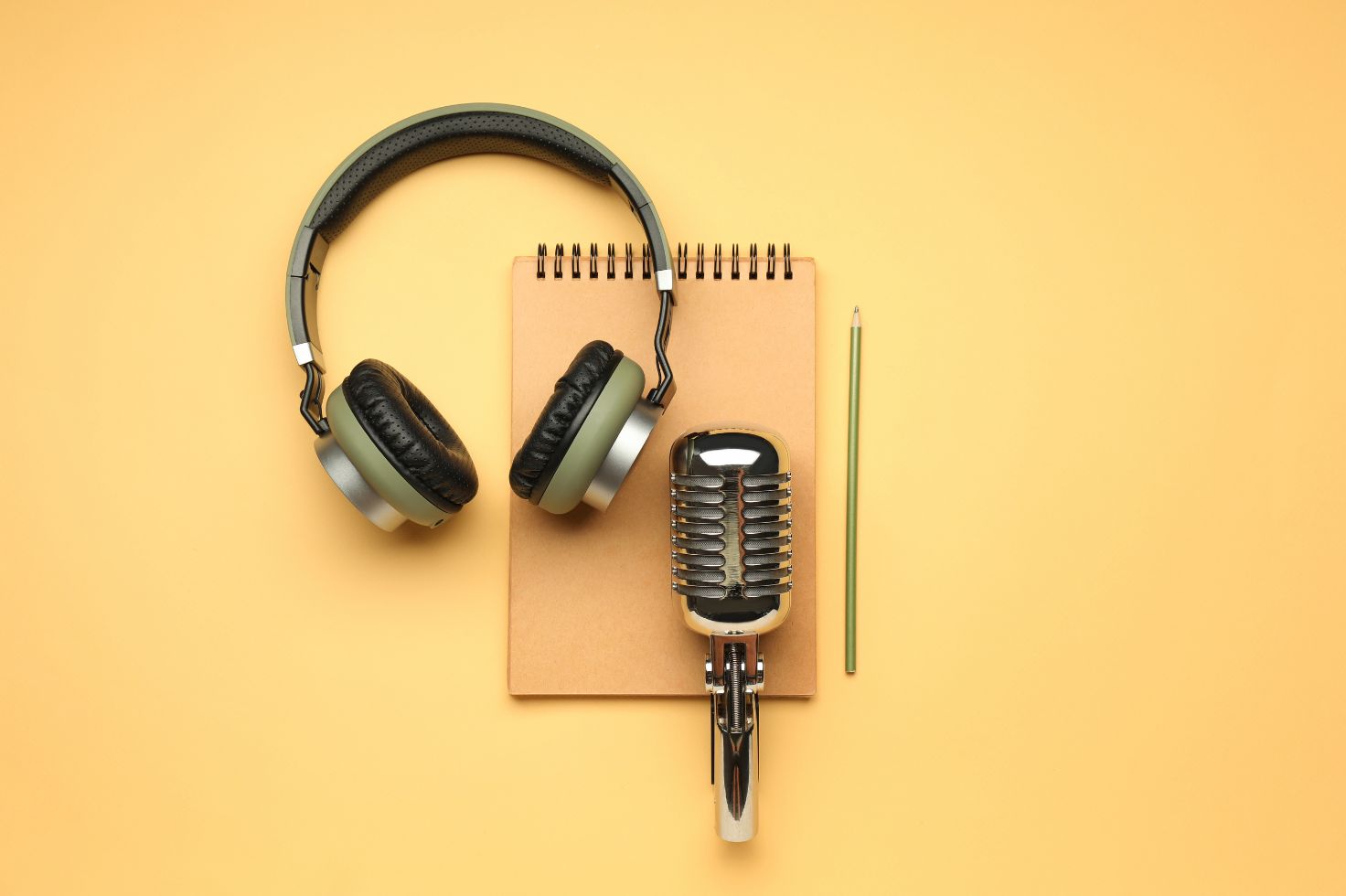 Headphones and microphone sitting on notebook